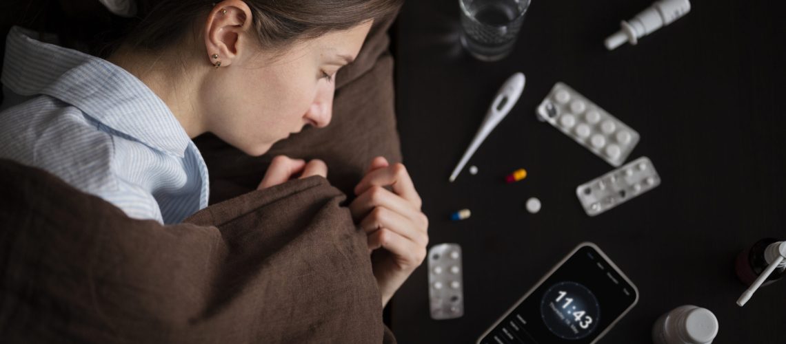 close-up-sick-woman-bed-with-pills